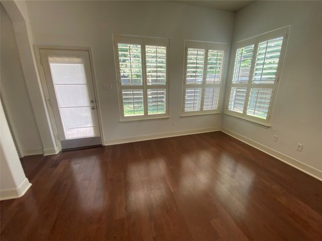 Spare room featuring dark wood-style flooring and baseboards | Image 12