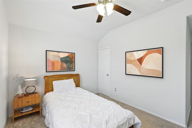 Bedroom featuring baseboards, lofted ceiling, a ceiling fan, and carpet | Image 8