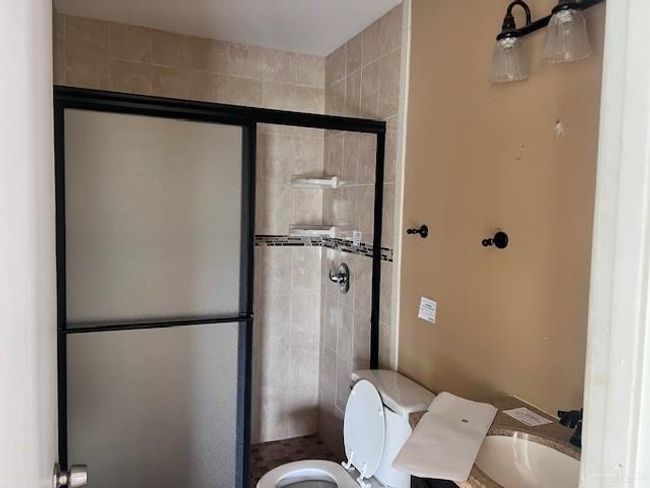 Full bathroom with toilet and a stall shower | Image 6