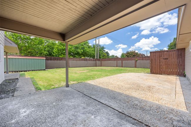 Fenced backyard with a patio and a storage shed | Image 17