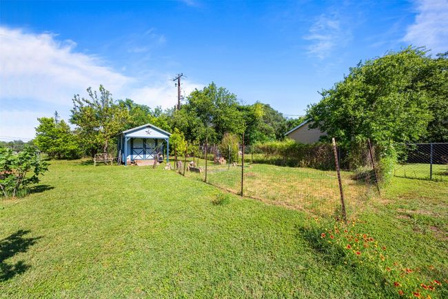 View of yard with a storage shed | Image 29