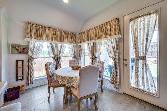 Dining room featuring vaulted ceiling and wood finished floors | Image 14
