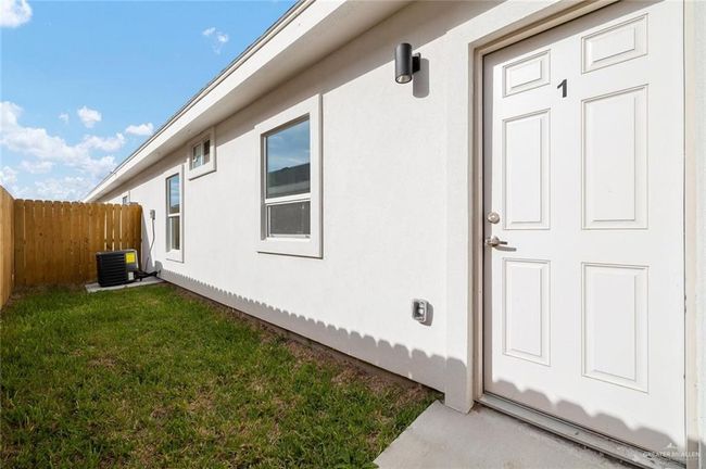 Entrance to property with central AC and stucco siding | Image 5