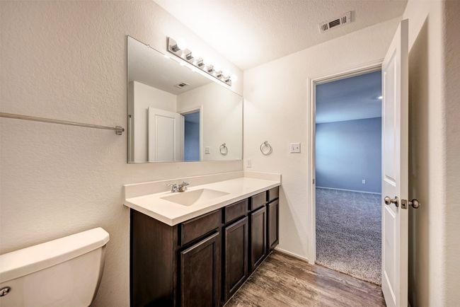 Bathroom featuring toilet, vanity, and wood finished floors | Image 19