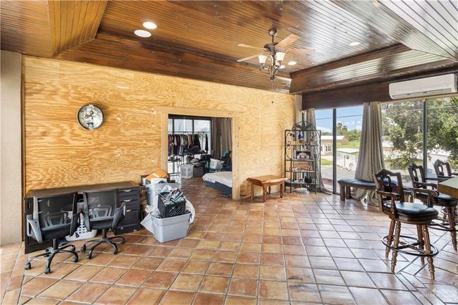 View of patio with a wall mounted air conditioner and a ceiling fan | Image 9
