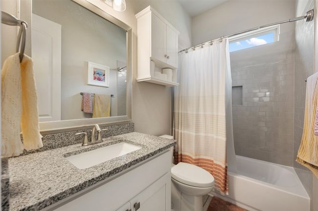 Bathroom featuring vanity and shower / bathtub combination with curtain | Image 22