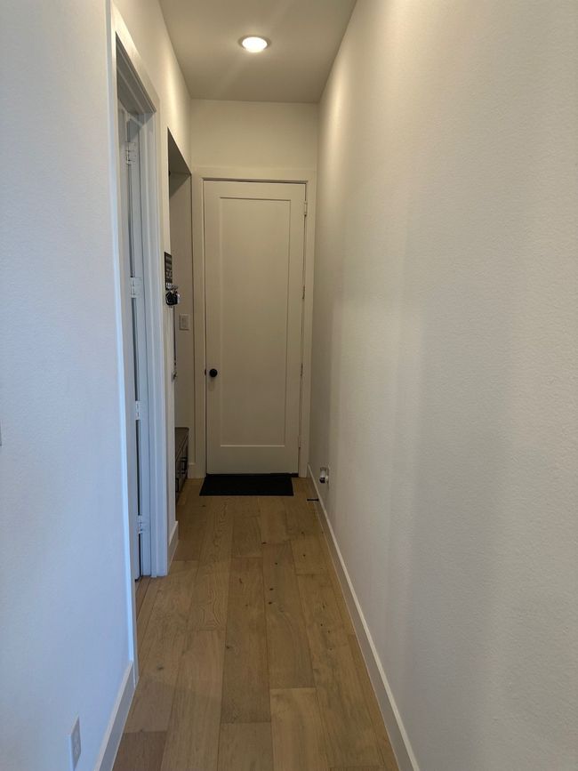 Hall with light wood-style floors and baseboards | Image 32