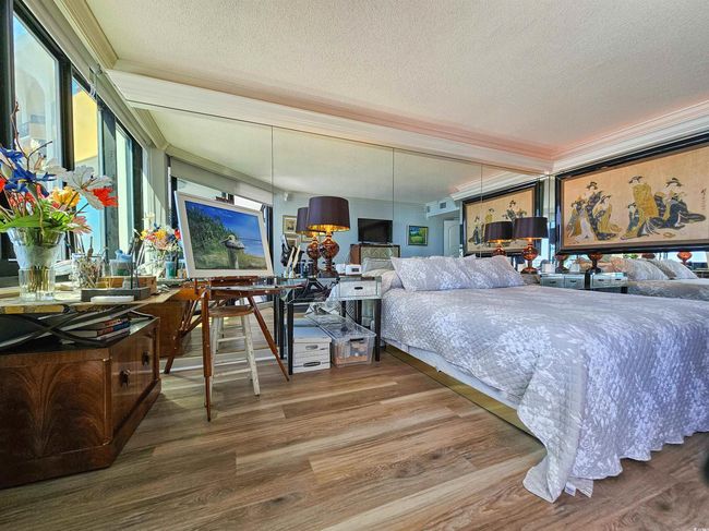 Bedroom featuring crown molding, a textured ceiling, and wood finished floors | Image 33