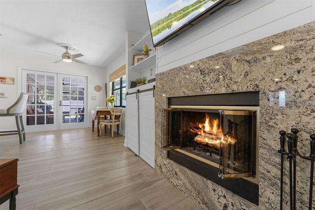 Family room includes a wood burning fireplace providing the perfect ambiance. | Image 11