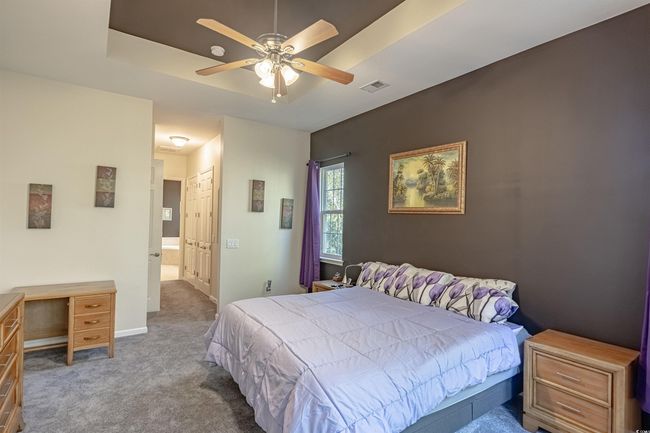 Carpeted bedroom with ceiling fan and a closet | Image 26