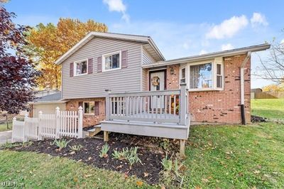 Back of house featuring a deck and a lawn | Image 3