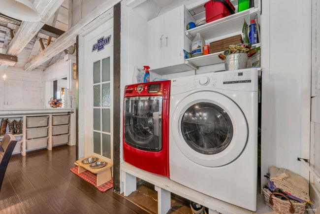 Laundry room featuring washing machine and dryer, wood finished floors, and laundry area | Image 15