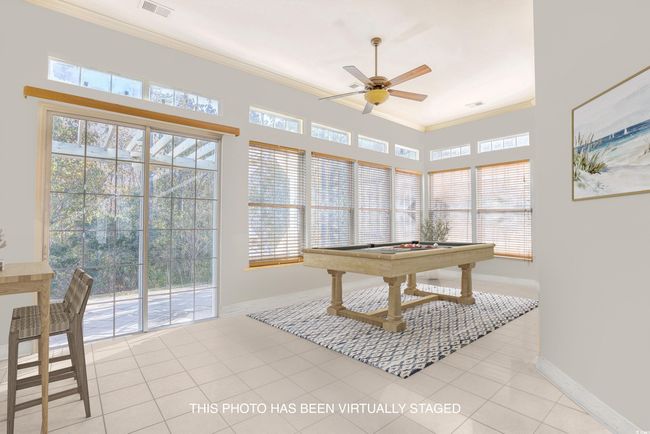 THIS ROOM HAS BEEN VIRTUALLY STAGED AS A REC ROOM. IT IS A CAROLINA ROOM WITH SLIDING GLASS DOORS TO THE BACKYARD. FULL OF LIGHT. | Image 15