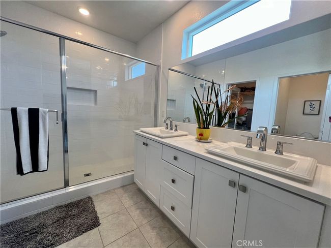 Primary bathroom with dual vanities. | Image 16