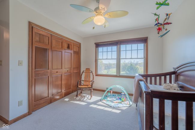 carpeted bedroom featuring a ceiling fan, baseboards, and a closet | Image 27