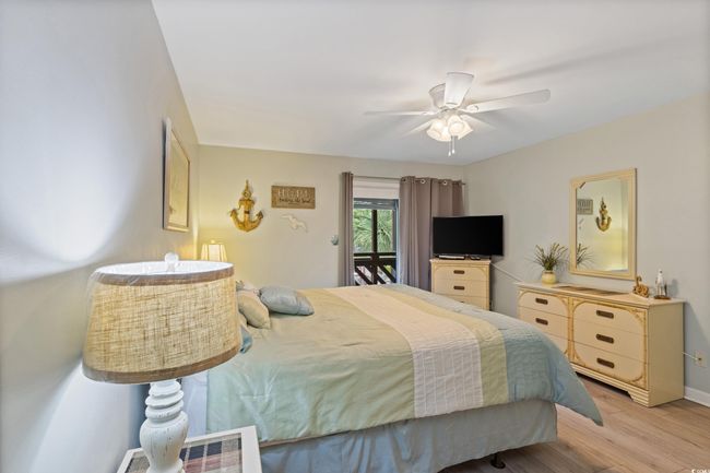 Bedroom featuring baseboards, light wood-style flooring, and ceiling fan | Image 25