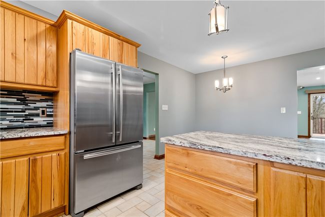 Another view of the kitchen with a close up of the granite counter tops | Image 11