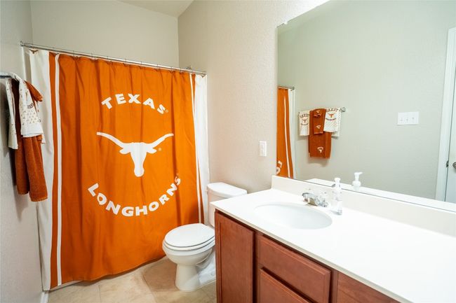 Bathroom with vanity, curtained shower, and tile patterned floors | Image 21