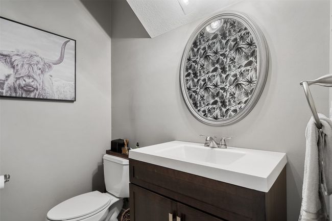Bathroom featuring toilet and vanity | Image 8