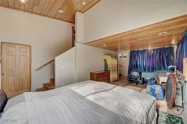 Bedroom with wooden ceiling, carpet flooring, and recessed lighting | Image 41