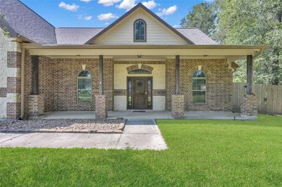 Charming 2-story home featuring a spacious covered front porch, brick exterior, and an inviting entrance, nestled in Rio Vista neighborhood. | Image 3