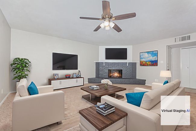 virtually staged-Living area featuring ceiling fan and a fireplace | Image 4
