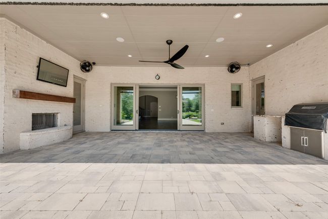 View of patio featuring ceiling fan and a fireplace | Image 37