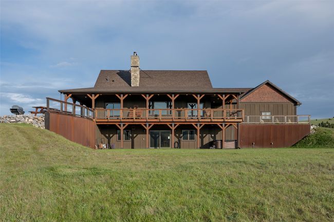 Back of property with a chimney, a yard, board and batten siding, and roof with shingles | Image 26