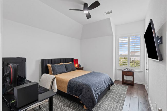 Bedroom with wood finished floors, baseboards, and a ceiling fan | Image 27