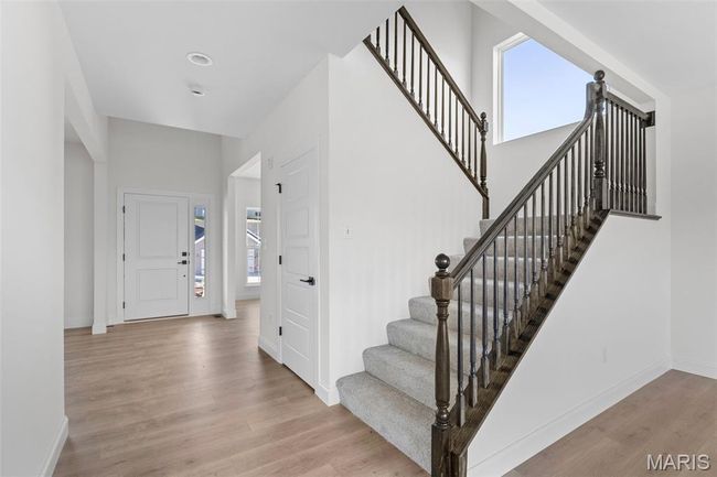 Foyer with wood finished floors and stairway | Image 26
