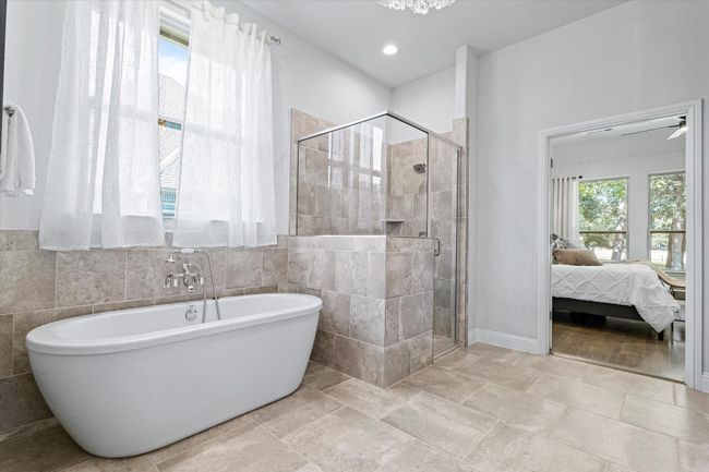 Ensuite bathroom with a soaking tub, a shower stall, and tile walls | Image 20
