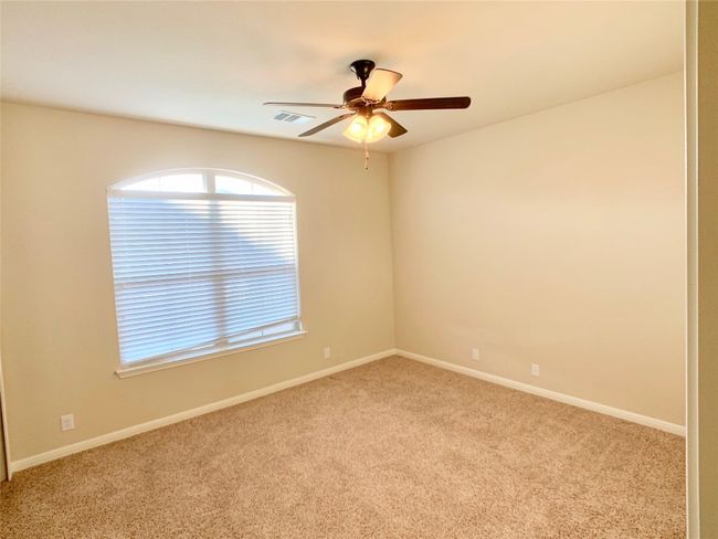 Carpeted empty room featuring ceiling fan, plenty of natural light, and baseboards | Image 7