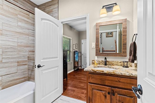 Bathroom featuring vanity and hardwood / wood-style flooring | Image 13