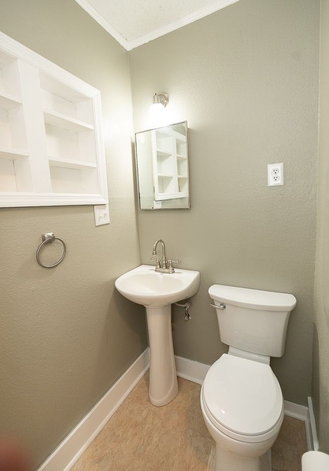 Half bathroom with baseboards and ornamental molding | Image 31