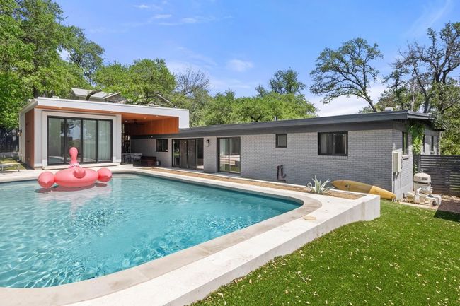 Outdoor pool featuring a yard and a patio area | Image 31
