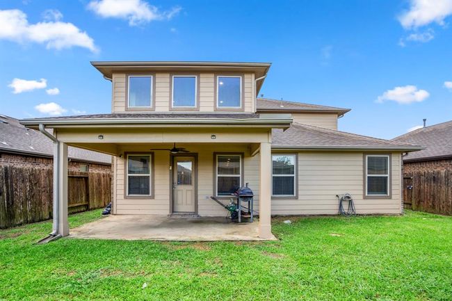A nice size covered patio with plenty of grassy area surrounding the backyard. | Image 41
