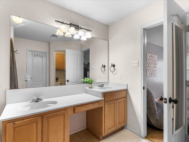 Bathroom with double vanity, ensuite bath, and tile patterned flooring | Image 18