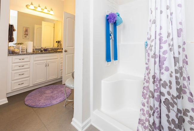 Full bath with tile patterned floors, baseboards, vanity, and curtained shower | Image 14