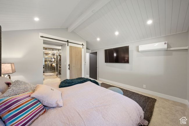 Carpeted bedroom with a wall unit AC, a barn door, baseboards, and recessed lighting | Image 14