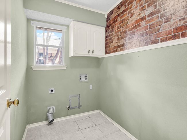 Laundry room is just across the hall from the half bath and accommodates a full size washer and gas or electric dryer. | Image 23