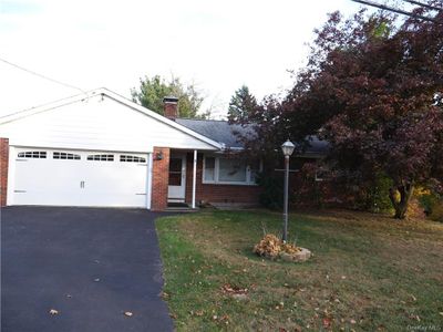 View of front of property featuring a front yard and a garage | Image 1