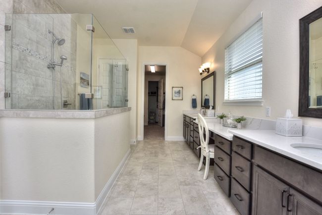 Full bath featuring a tile shower, visible vents, vanity, and baseboards | Image 24