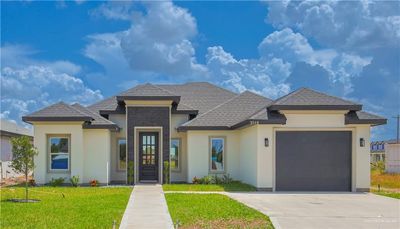 View of front of house with a garage and a front lawn | Image 1