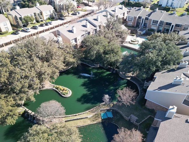 Aerial view of property's location featuring nearby suburban area and a large body of water | Image 21