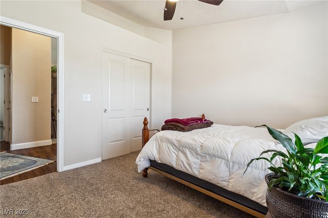 Carpeted bedroom with a ceiling fan, baseboards, and a closet | Image 23