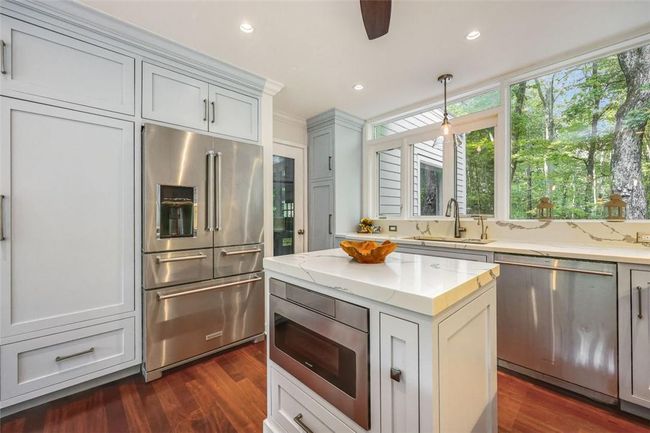 Kitchen featuring pendant lighting, dark hardwood / wood-style flooring, sink, ceiling fan, and appliances with stainless steel finishes | Image 8