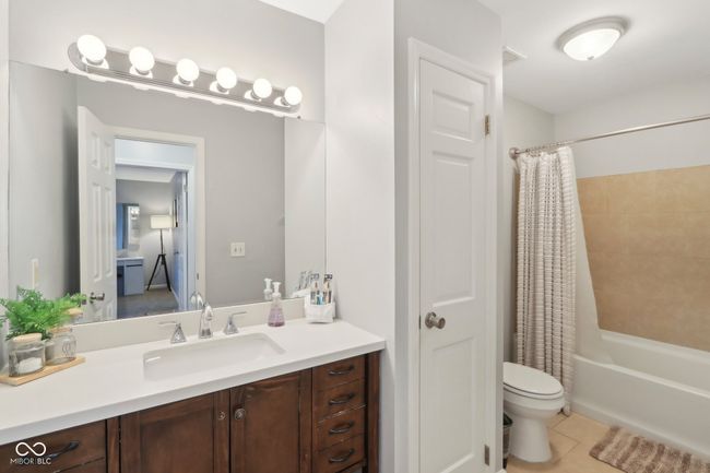 full bathroom featuring toilet, visible vents, shower / tub combo, tile patterned flooring, and vanity | Image 18