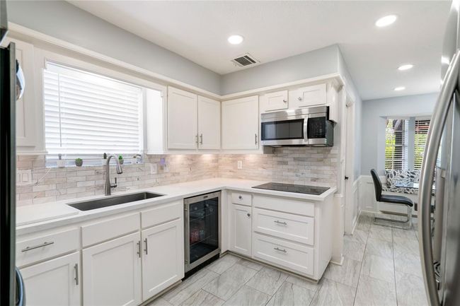 Kitchen has a wine refrigerator/beverage center | Image 11