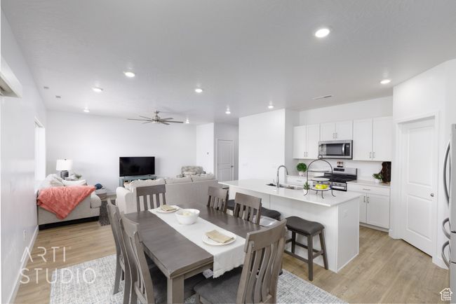 Dining area with light wood finished floors, recessed lighting, and a ceiling fan | Image 16