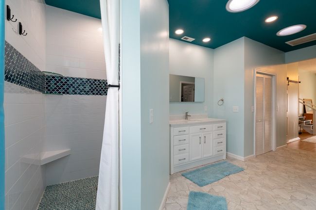 Large bathroom with separate tiled shower, skylights, and custom tile | Image 18